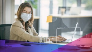 Masked woman working on her computer