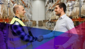 an employee shaking hands with a recruiter in a warehouse