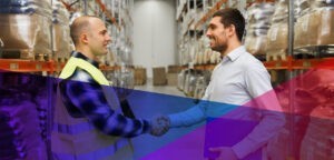 an employee shaking hands with a recruiter in a warehouse