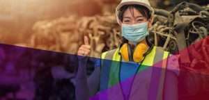 Female industrial worker giving a thumbs up