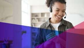 A woman wearing a headset in front of a computer