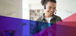 A woman wearing a headset in front of a computer