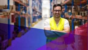 man in a safety vest with crossed arms in a warehouse