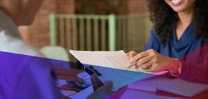 a hiring manager pointing to an item on a candidate's CV