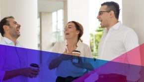 a group of employees having a friendly conversation in the workplace