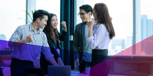 a group of coworkers talking in an office setting