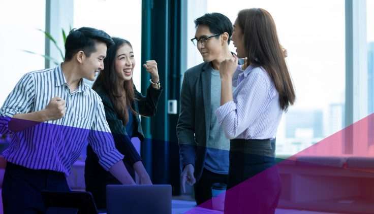 a group of coworkers talking in an office setting